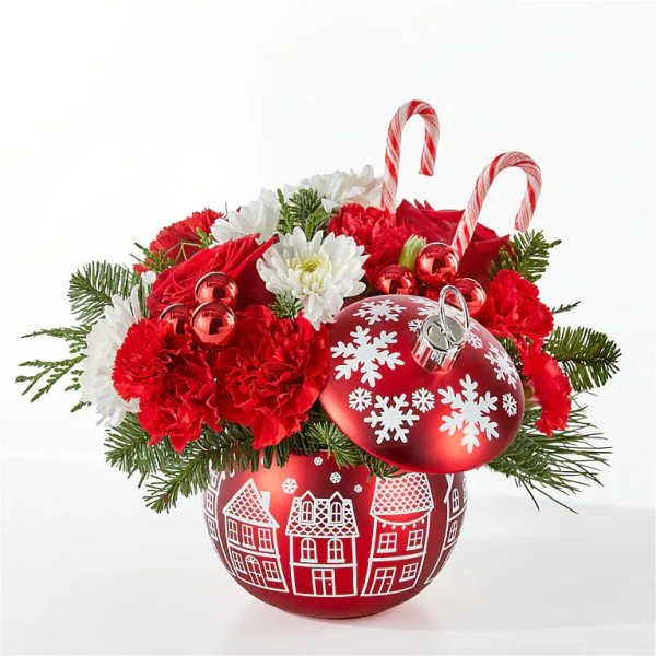 Christmas floral arrangement in a red ornament container with candy canes