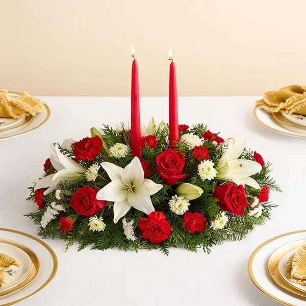 Red and white floral centerpiece with two red candles