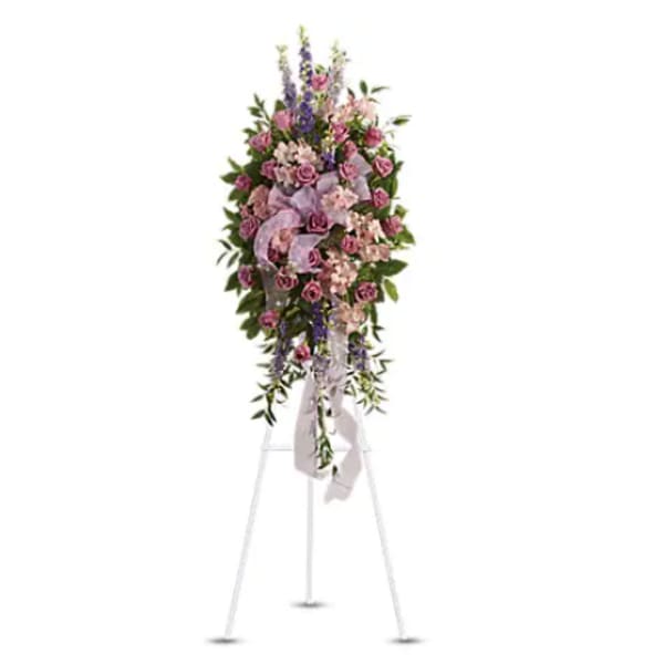 Tall pink and purple floral standing spray on an easel