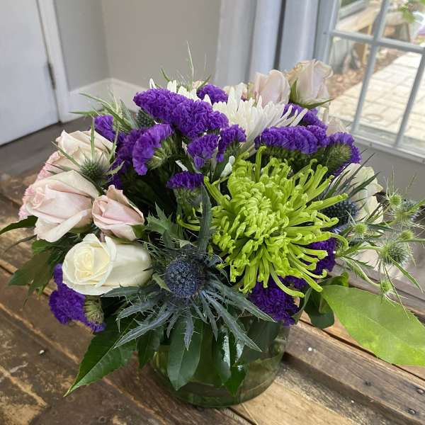 Bouquet of purple and white flowers in a glass vase