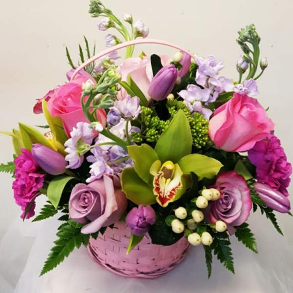 Pink and lavender flower basket with roses and orchids