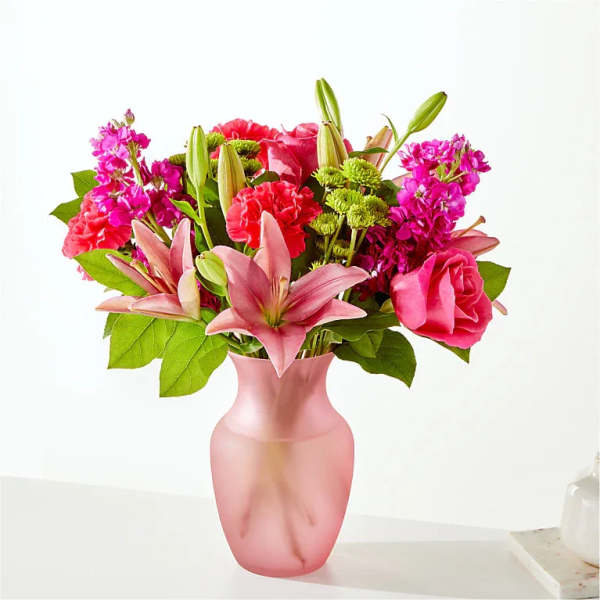 Pink and magenta bouquet in a frosted pink vase