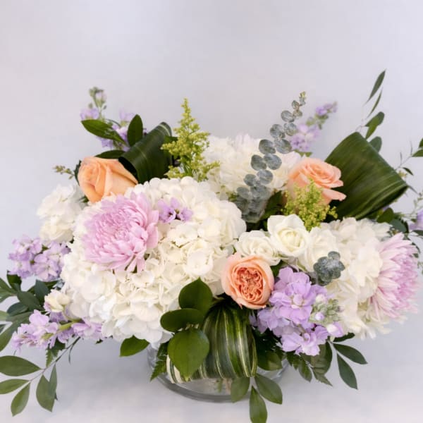 Bouquet of white and pastel flowers in a glass vase