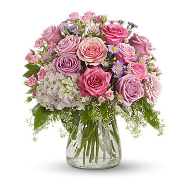 Pink and lavender rose bouquet in a clear glass vase