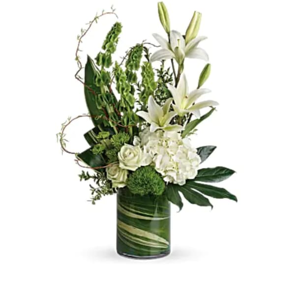 White lilies and roses arranged in a green glass vase