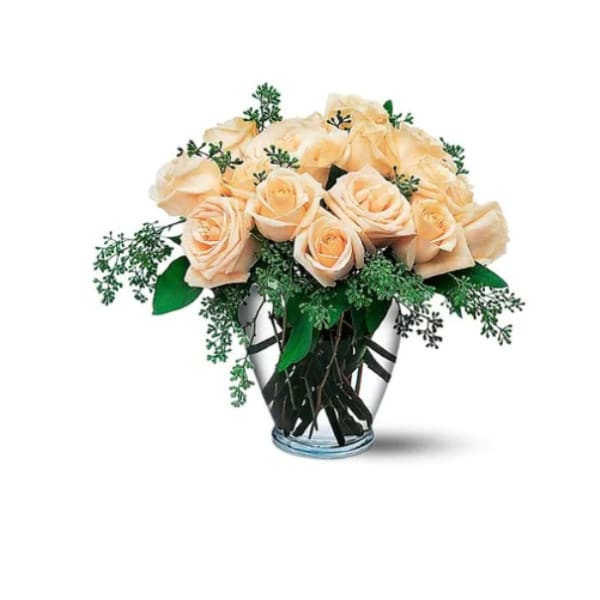 Peach roses arranged in a clear glass vase