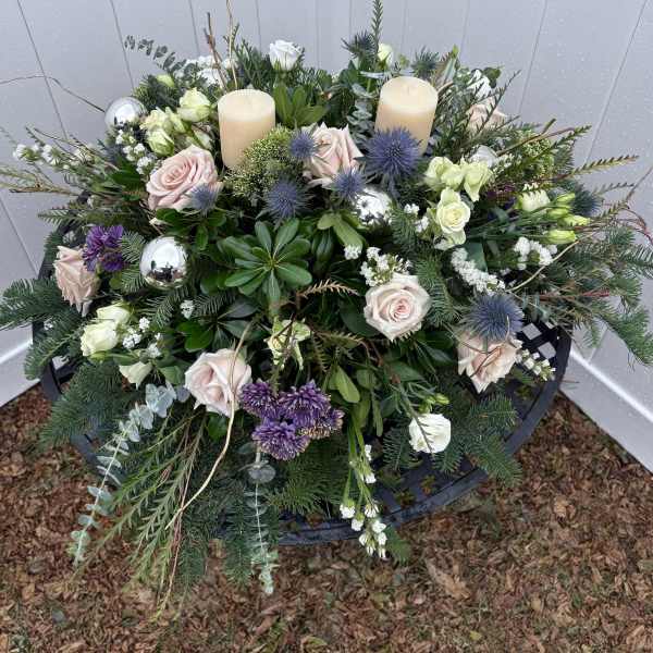 Floral wreath with roses, thistles, and candles