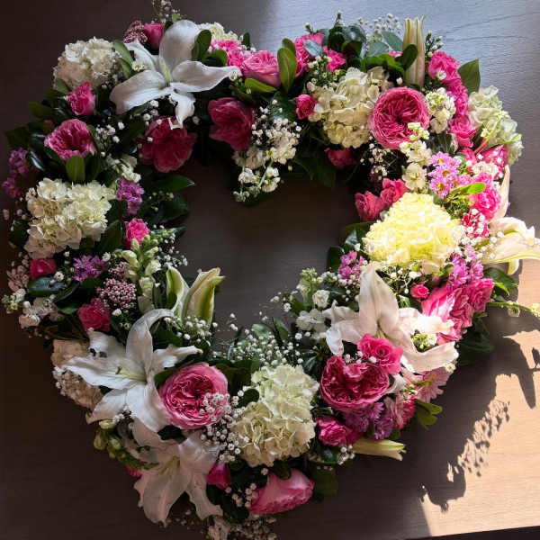 Heart-shaped floral wreath with pink and white flowers
