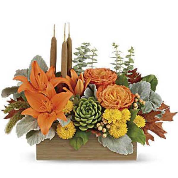 Orange lilies and roses in a wooden box with candles