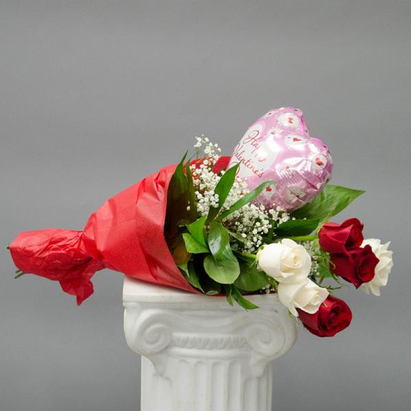 Bouquet of red and white roses with a pink heart balloon