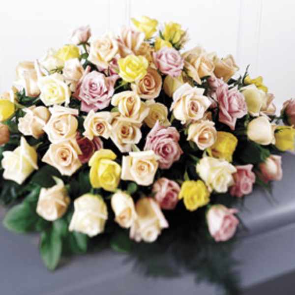 Large bouquet of pastel roses in cream, pink, and yellow