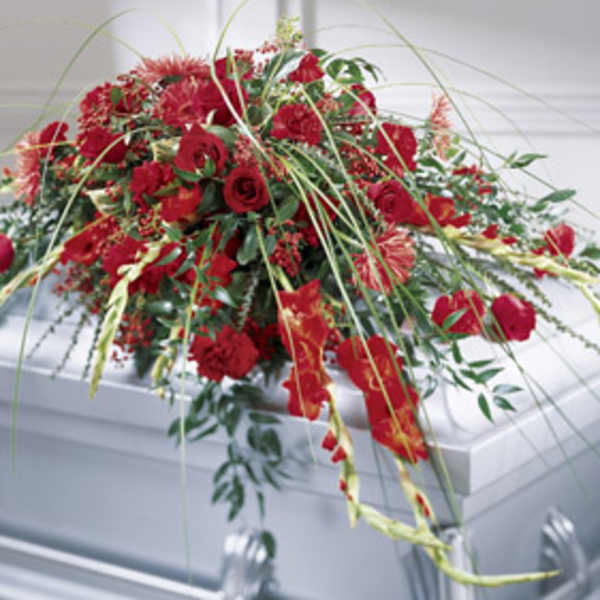 Red floral casket spray with roses and carnations