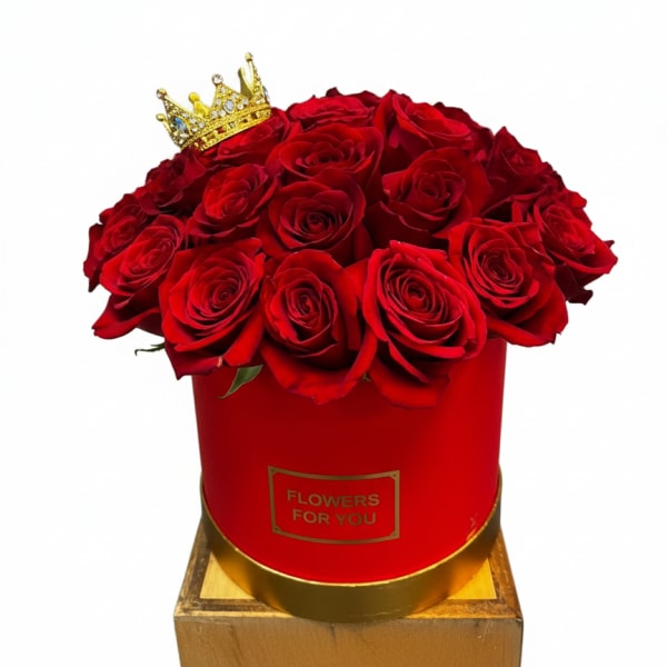 Red roses in a red hat box with a small gold crown