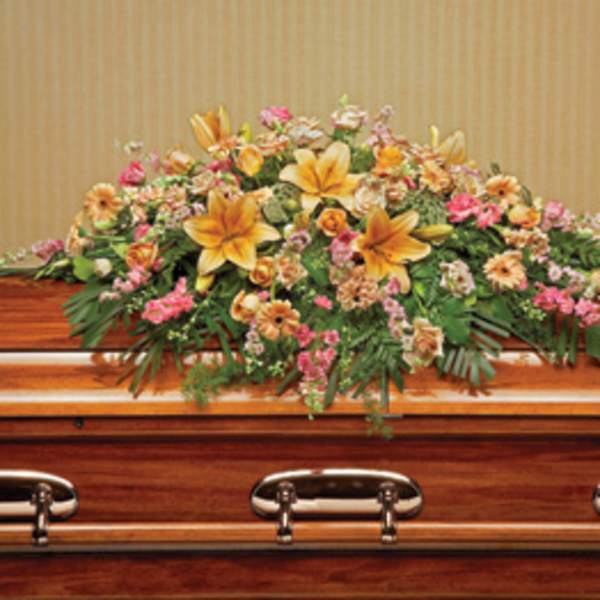 Large floral spray on a wooden casket