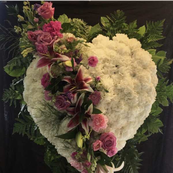 Heart-shaped white floral spray with pink roses and lilies