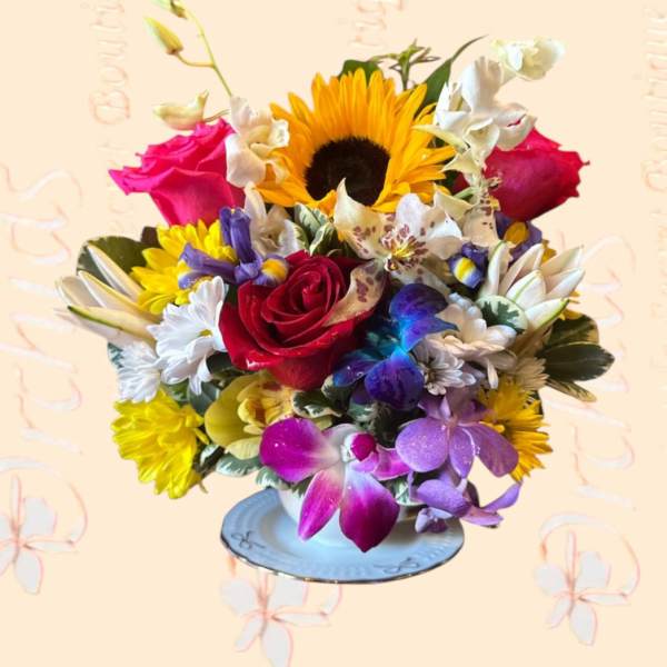 Colorful mixed bouquet with a sunflower, roses, and orchids in a vase