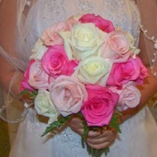 Bride holding a bouquet of pink and white roses