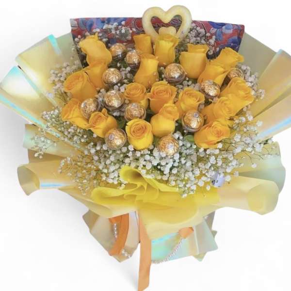 Bouquet of yellow roses with baby’s breath and gold-wrapped chocolates