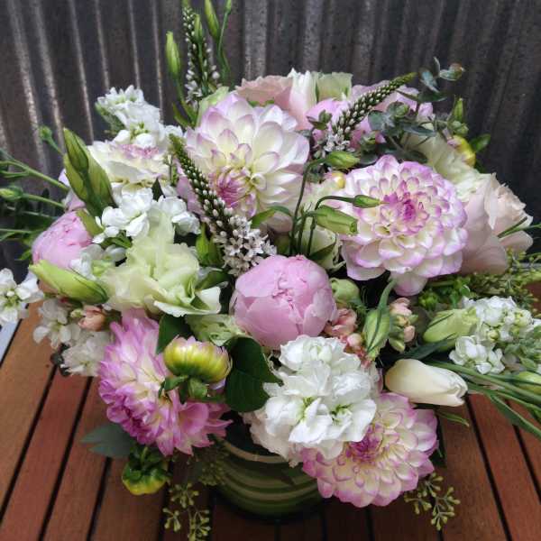 Pink and white mixed bouquet in a green vase