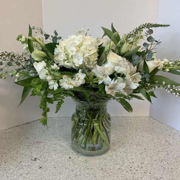 White floral arrangement in a clear glass vase