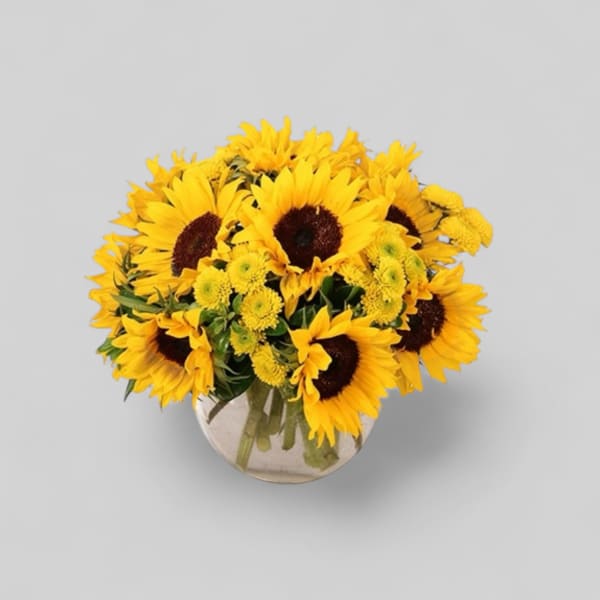 Bouquet of yellow sunflowers in a clear glass vase