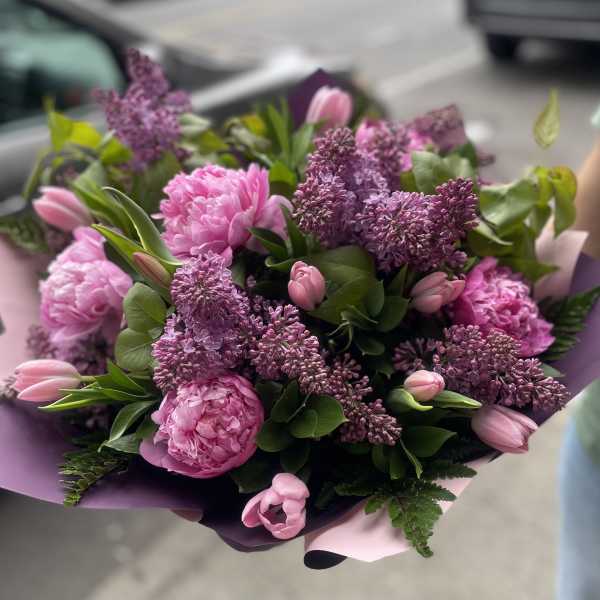 Lilac with peonies and tulips bouquet. The photo shows a deluxe size.