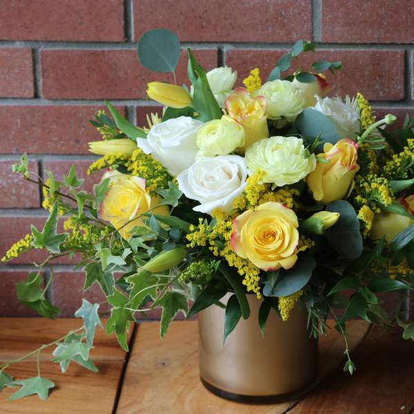 Yellow and white rose bouquet in a gold vase