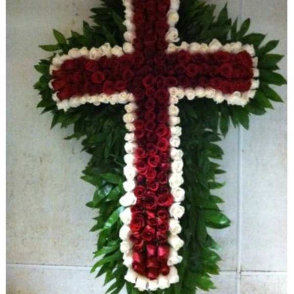 Cross-shaped floral arrangement of red and white roses