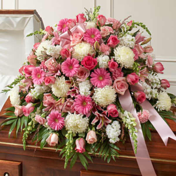 Large pink and white floral casket spray with ribbon