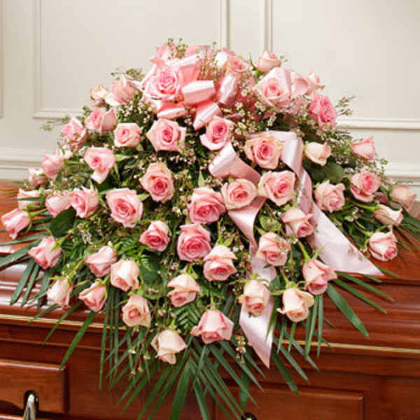 Pink rose casket spray with ribbon accents