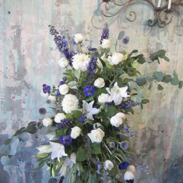Tall white and purple floral spray on a stand