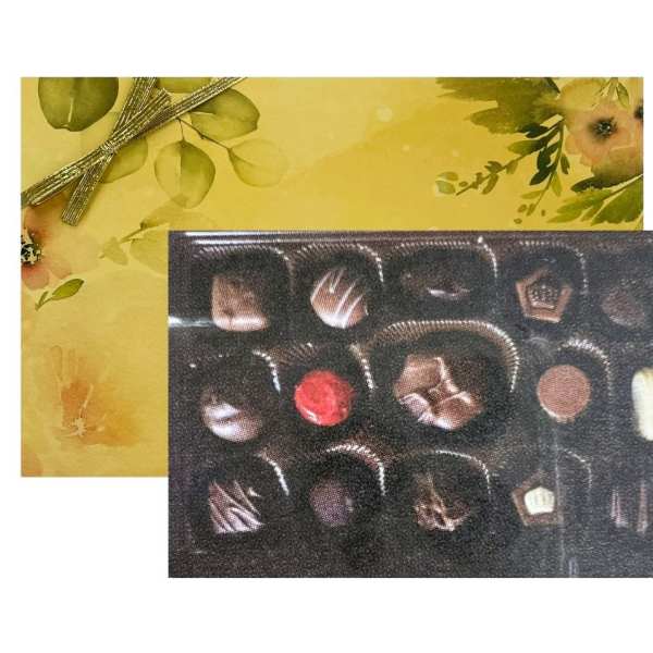 Rectangular gift box of assorted chocolates with a yellow floral lid and gold ribbon.