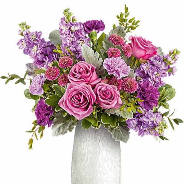 Pink and purple flower arrangement in a white vase