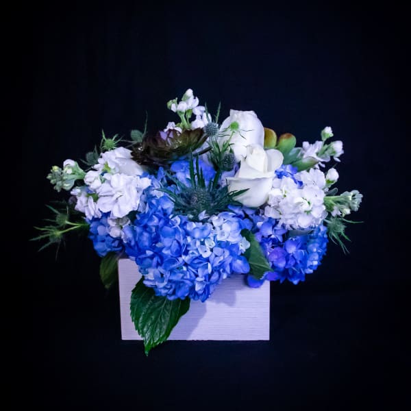 Blue and white floral arrangement in a white box