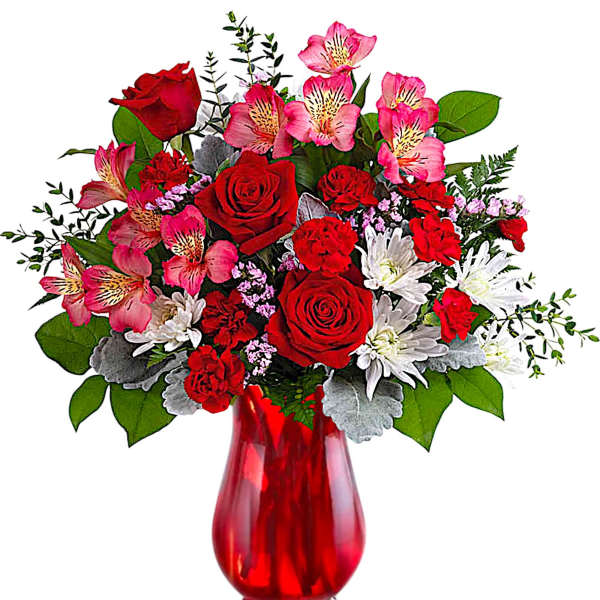 Red roses and pink alstroemeria in a red glass vase