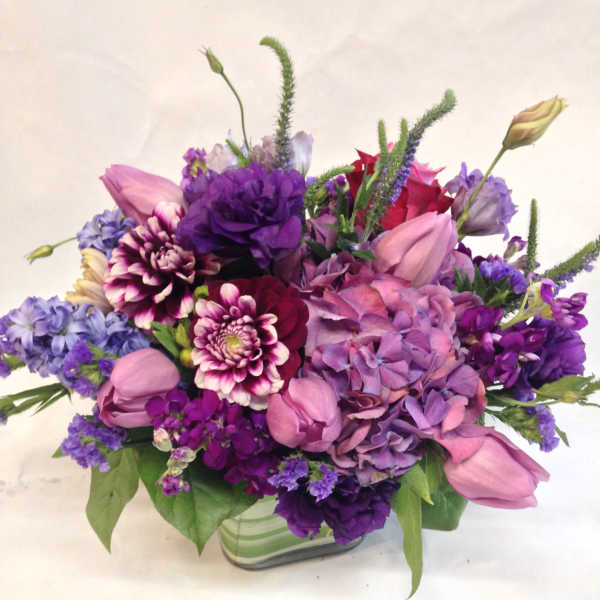 Purple and pink mixed bouquet in a glass vase