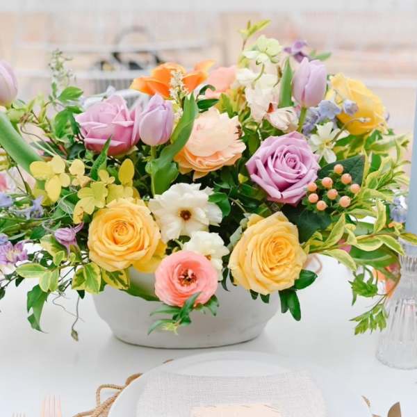 Pastel mixed flower arrangement in a white bowl vase