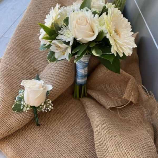 White rose and daisy bouquet with a matching boutonniere
