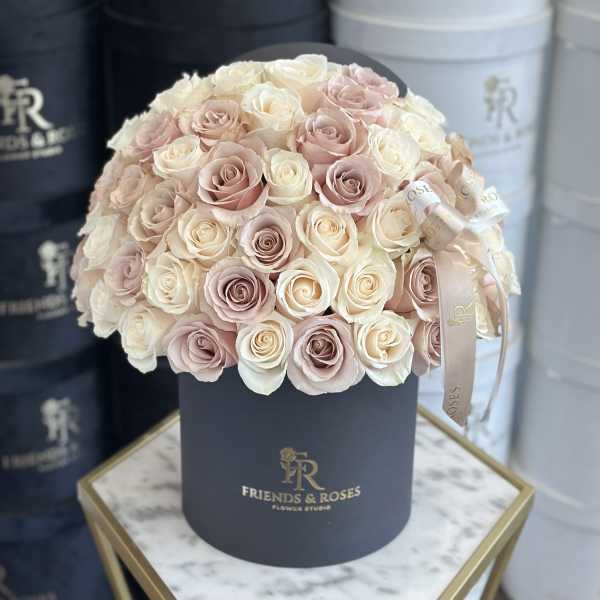 Round bouquet of blush and ivory roses in a black hat box