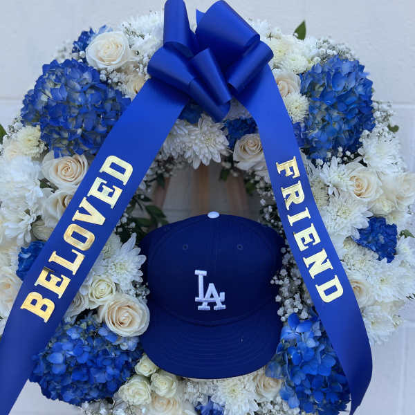 Blue and white floral wreath with a ribbon and baseball cap