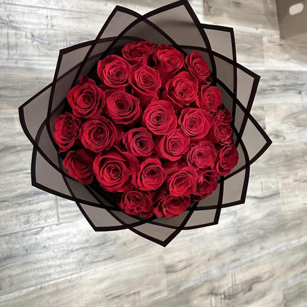 Bouquet of red roses wrapped in black paper