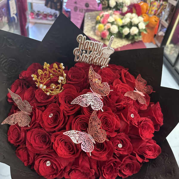 Bouquet of red roses with butterfly picks and a Happy Birthday topper