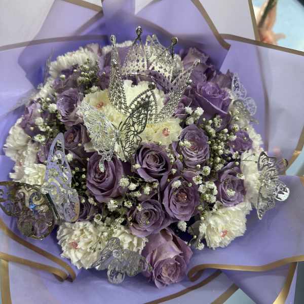 Purple and white bouquet with butterfly decorations and a crown topper