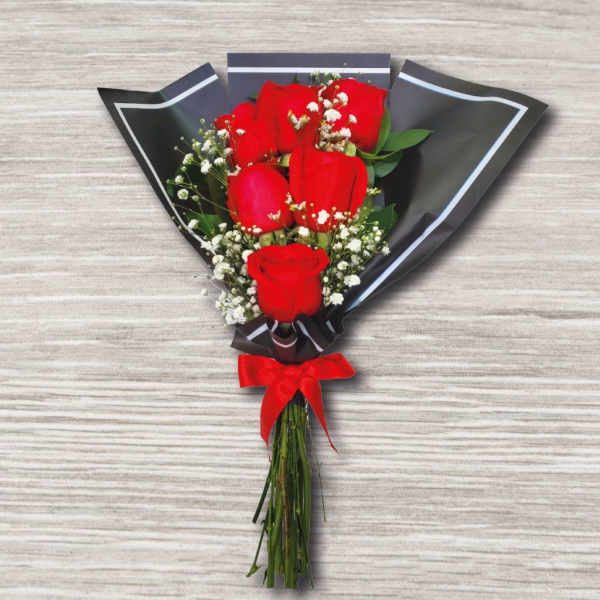 Bouquet of red roses wrapped in black paper with a red ribbon
