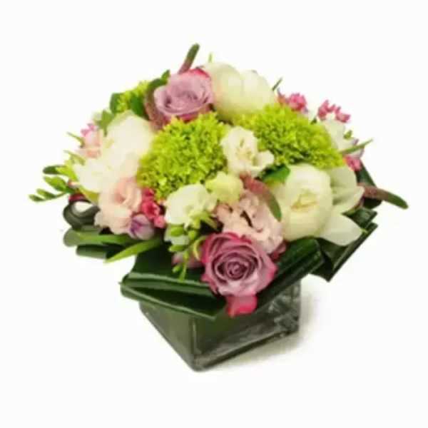 Pink and white mixed flower arrangement in a square glass vase