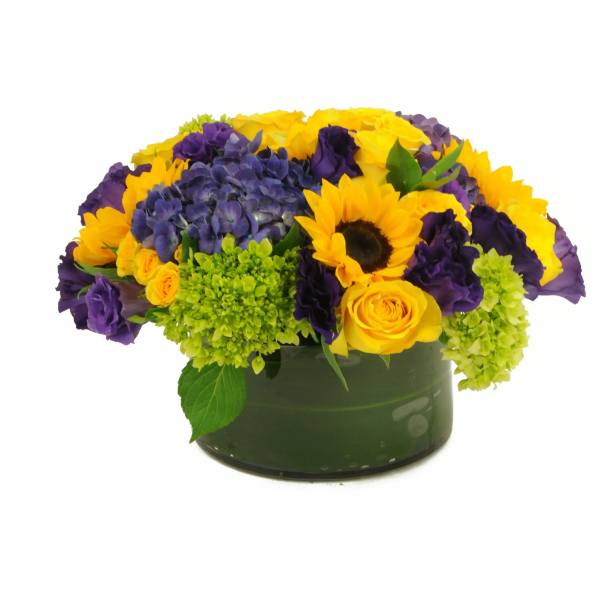 Yellow sunflowers and purple flowers arranged in a green vase