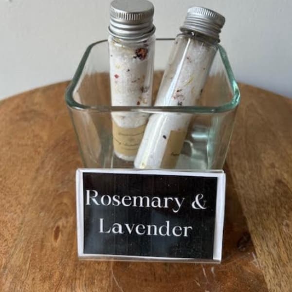 Two small glass vials in a square glass holder labeled Rosemary & Lavender