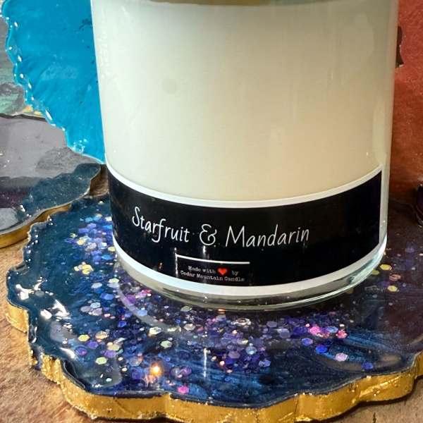 Scented candle in a glass jar with a bronze lid