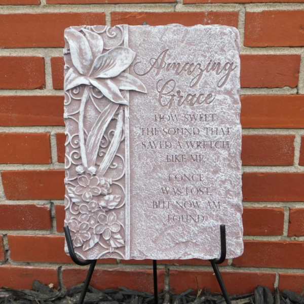 Decorative stone plaque with floral relief and the words "Amazing Grace"