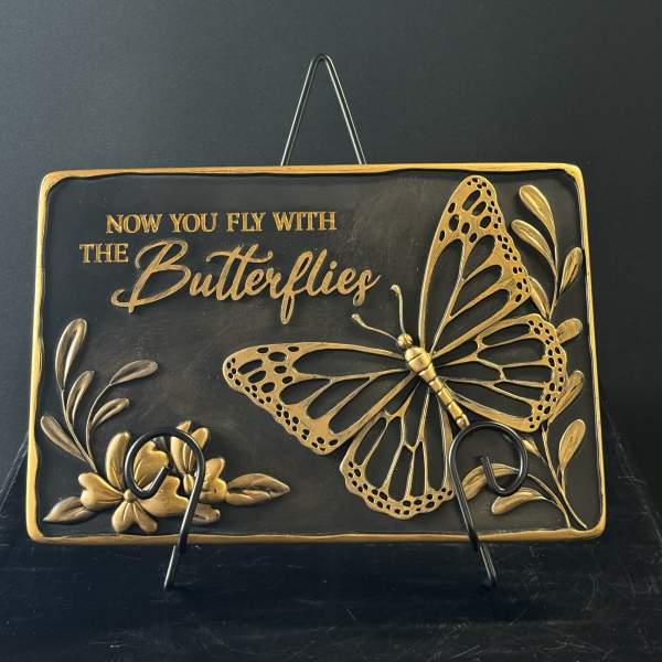 Decorative plaque with a gold butterfly and floral accents